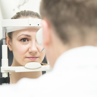 Woman getting eye exam with doctor