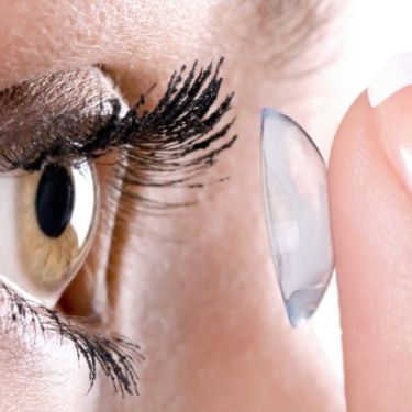 woman applying contact lense