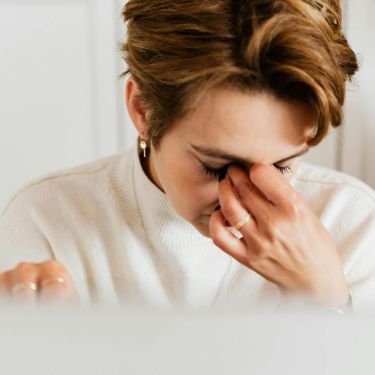 Woman rubbing itchy red eyes from seasonal allergies