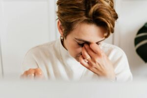 Woman rubbing itchy red eyes from seasonal allergies